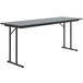 A rectangular Correll seminar table with gray granite top and black legs.