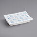 A white rectangular foam brick cold pack with blue and white designs on the package.
