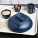 A tray with a blue bowl and a blue plate covered with a navy blue lid, with blue mugs of coffee.