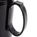 A close-up of a black Cambro insulated mug with a handle.