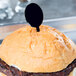 A hamburger with a black WNA Comet oval pick on top.