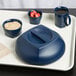 A tray with a blue bowl of oatmeal and a blue Cambro insulated mug with a lid on it.