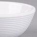 A close-up of a white Tablecraft ramekin with a ribbed design.