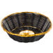 A black and gold Thunder Group rattan basket with a handle.