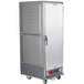 A large gray Metro C5 heated holding and proofing cabinet with a solid door on wheels.