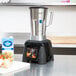 A Waring commercial blender on a counter.