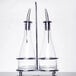 A Tablecraft Siena oil and vinegar cruet set with two glass bottles and a chrome stand.