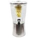A Tablecraft stainless steel and glass beverage dispenser with a lemon inside.