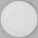 A Libbey Porcelana white porcelain plate with a wide white rim on a gray surface.