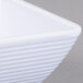 A close up of a white Tablecraft square ribbed melamine ramekin.