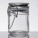 A Tablecraft clear glass salt and pepper shaker jar with a stainless steel clip-top lid.