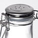 A Tablecraft glass salt shaker with a stainless steel clip-top lid.