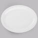 A white Libbey Porcelana oval platter with a white rim on a gray surface.