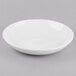 A Libbey bright white porcelain low bowl on a grey surface.
