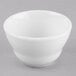 A Libbey Porcelana white bowl on a gray surface.