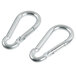 A pair of silver metal hooks on a white background.