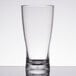 A close-up of a clear GET SAN plastic shot glass on a table.