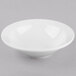 A Libbey bright white porcelain grapefruit bowl on a white surface.