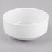 A white Libbey Porcelana bowl on a gray surface.