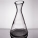 A clear glass Stolzle Pisa carafe with a clear bottom.
