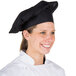A woman wearing a black Intedge chef hat.