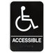 A black and white Vollrath sign with the word "Accessible" and a wheelchair symbol.