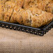 A black rectangular grid basket with croissants on it.