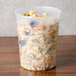A Pactiv translucent plastic deli container filled with pasta.
