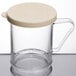 A clear Cambro polycarbonate shaker with a beige lid.