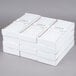 A stack of white boxes filled with white Hyoola taper candles.