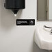 A black and white Vollrath Employees Must Wash Hands sign above a sink.