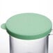 A clear polycarbonate shaker with a green lid.