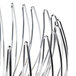 A close-up of a Clipper Mill chrome plated iron wire basket with black and white metal spirals.