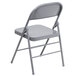A gray Flash Furniture metal folding chair with a folding frame.