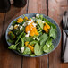 A 10 Strawberry Street Biseki stoneware plate with a spinach salad with oranges and cheese.