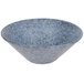 A close-up of a blue Biseki stoneware coupe bowl with a speckled surface.