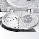 A Robot Coupe 3/16" metal grating / shredding disc with holes in it.