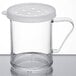 A clear polycarbonate shaker with a white lid containing parsley.