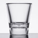 A clear SAN plastic shot glass with a clear glass on top.
