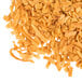 A pile of Sweet Toasted Coconut Flakes on a white background.