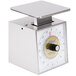 An Edlund stainless steel portion scale with a white dial on a kitchen counter.