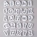 A set of white plastic alphabet and number cookie cutters.