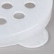 A white plastic shaker lid with holes.