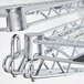 A close up of a Metro chrome double wall mount bracket for adjoining shelves.