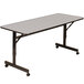 A gray rectangular Correll EconoLine mobile flip top table with wheels.