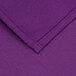 A purple rectangular cloth table cover with hemmed edges and a red stitch.