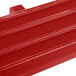 A red plastic tray rail with slats for a table.
