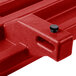 A red plastic tray rail with a black knob.