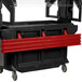 A black and red Cambro tray rail on a table with a red top.