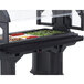 A black tray rail attached to a table with a tray of food in a salad bar.